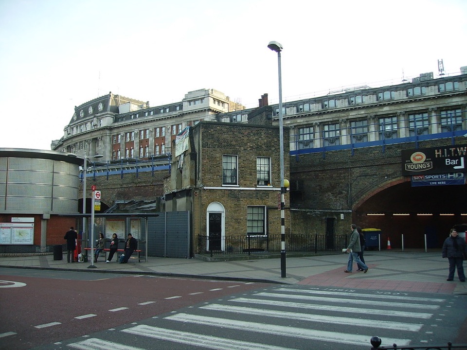 A surviving brick terrace house squeezed between larger buildings near Waterloo, London
